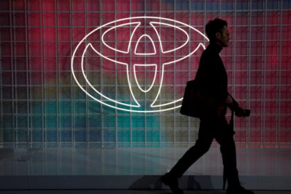 A man walks past a Toyota logo at the Tokyo Motor Show, in Tokyo, Japan October 24, 2019. REUTERS